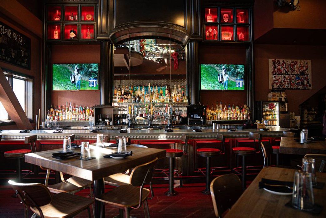 bartender pouring a cocktail